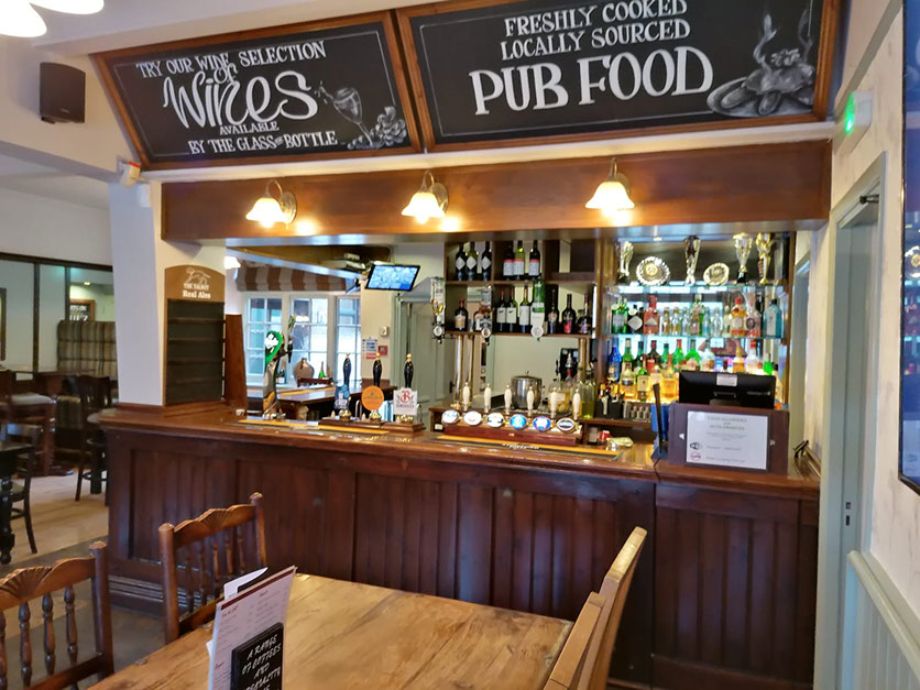 Bar at The Talbot Inn pub in Stilton, Cambridgeshire, offering real ales, wines, and locally sourced freshly cooked food.